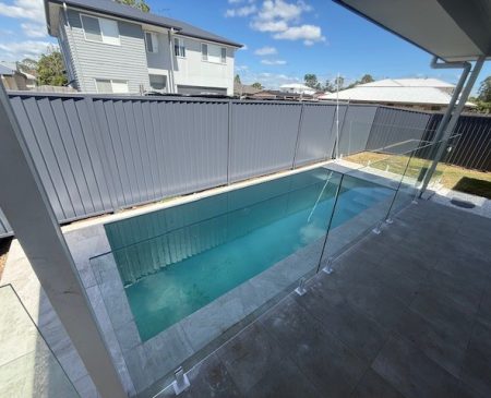 boondall-swimming-pool-1 Compact backyard swimming pool with a glass pool fence